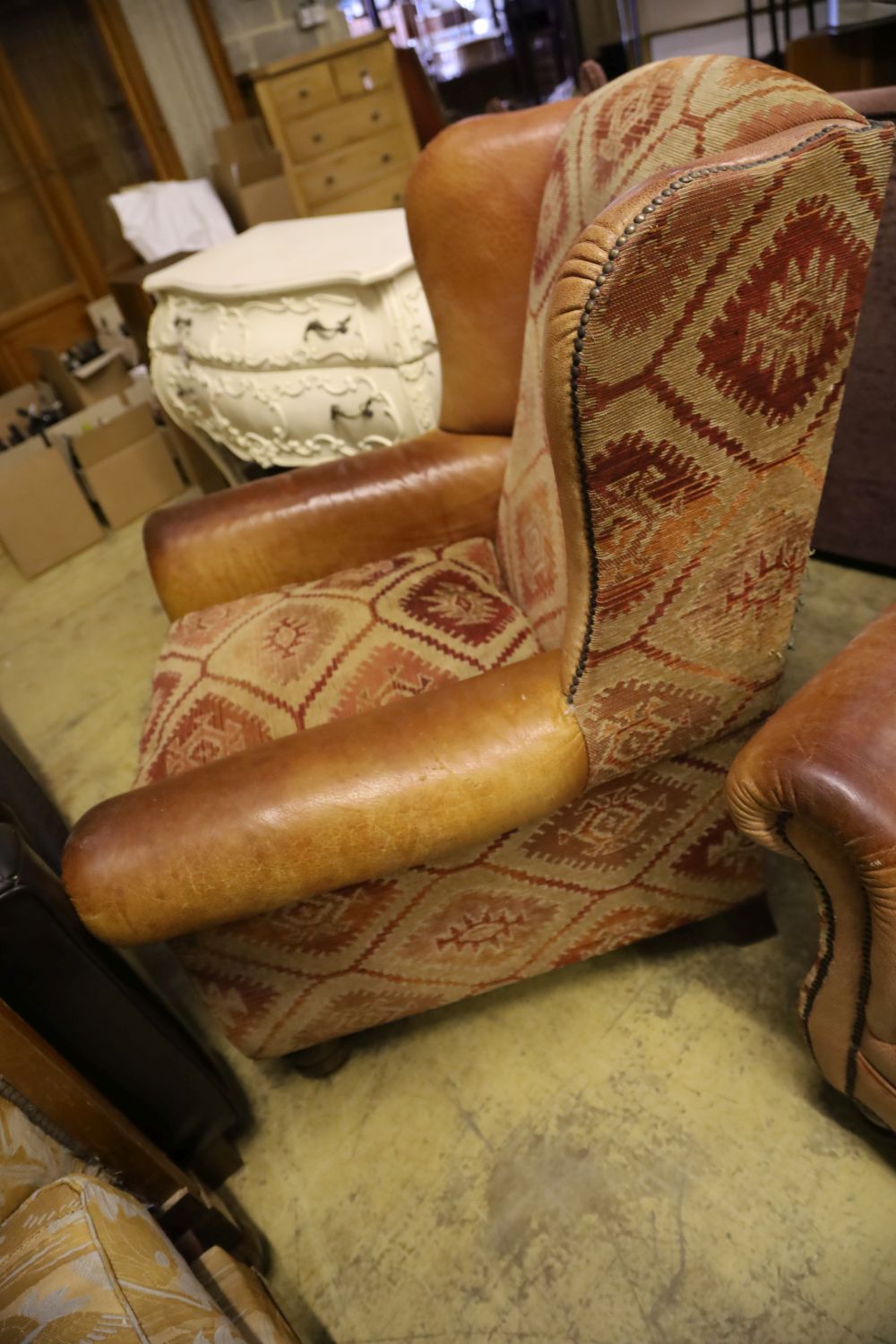 A pair of Tetrad style leather and kelim fabric upholstered wing club armchairs